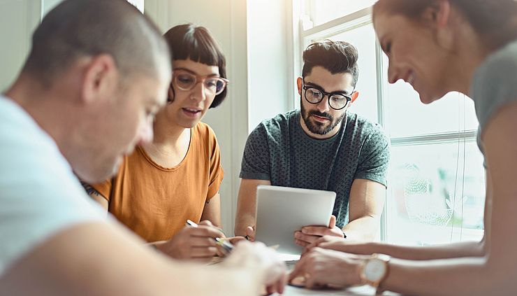 Gruppe von jungen Kollegen arbeitet zusammen 